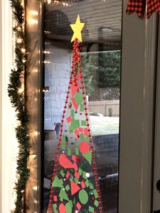 This Christmas Tree Craft For Kids Will Be A Hit For The Holidays! This Activity Uses Contact Paper To Create A Fun And Unique Christmas Craft Experience. #christmascrafts #christmascraftsforkids