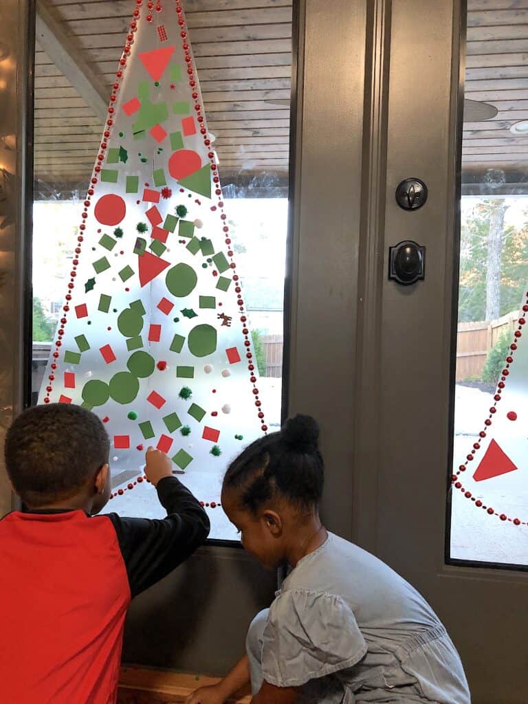 This Christmas Tree Craft For Kids Will Be A Hit For The Holidays! This Activity Uses Contact Paper To Create A Fun And Unique Christmas Craft Experience. #christmascrafts #christmascraftsforkids